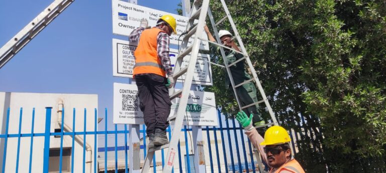 Installing plates on construction signboard